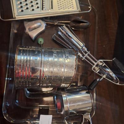Cake pan, flour sifter, egg beater, cheese grater and other items