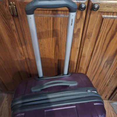 Delsey spinner large luggage in purple- hard case, 4 wheels spins smoothly