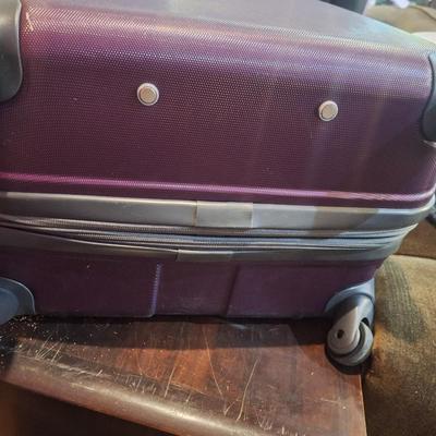 Delsey spinner large luggage in purple- hard case, 4 wheels spins smoothly