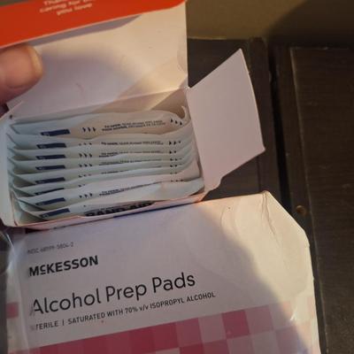 bundle of alcohol prep pads and some gauze pads