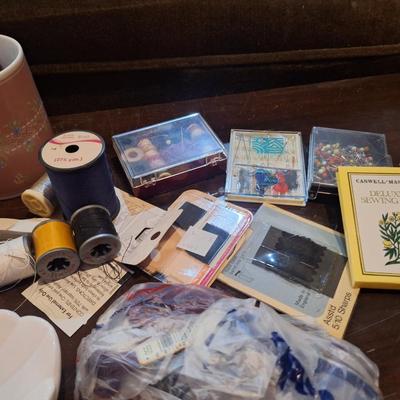 crafty things, sewing kits, thread, coffee cup, candle holder with battery mini Led string lights and swan dish.