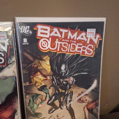  two issues of the DC comic book series Batman and the Outsiders 