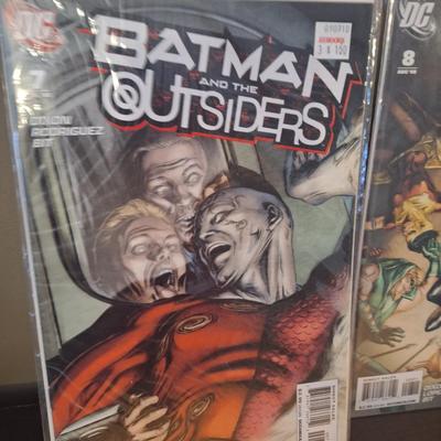  two issues of the DC comic book series Batman and the Outsiders 