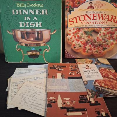 vintage cookboox and pamplets, the stoneware book has been heavily used- it has a bend to it.