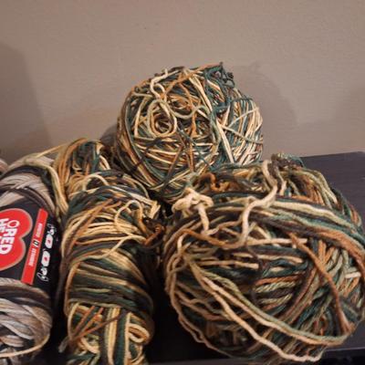 Yarn bundle, camo colors, 2 skeins are browns the rest has greens.