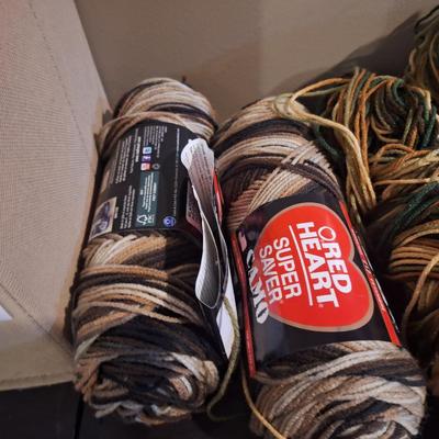 Yarn bundle, camo colors, 2 skeins are browns the rest has greens.