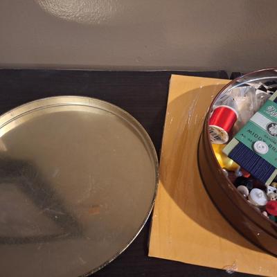 metal tin of buttons and sewing related
