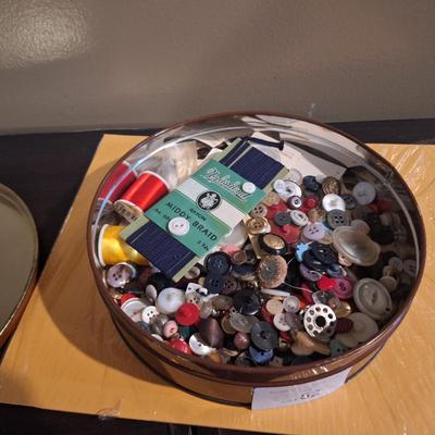 metal tin of buttons and sewing related