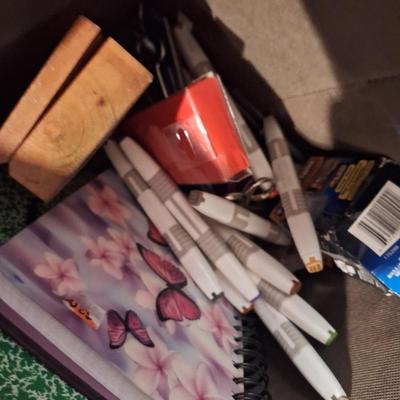 fabric container fo misc office items, markers, half full spiral notebooks, full writing pad, random things, 