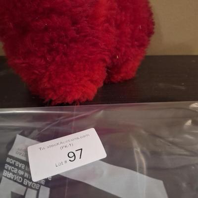 This is a red, handmade alpaca fur plush toy. 