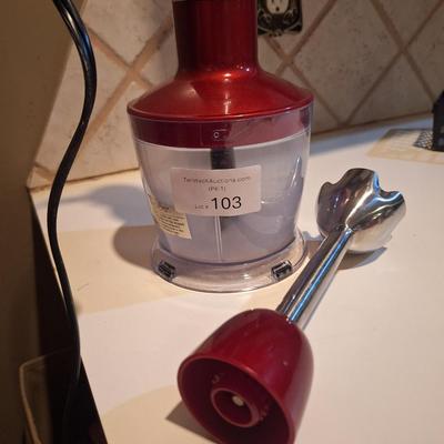 Red and silver immersion hand blender that also has a base- use it either way.