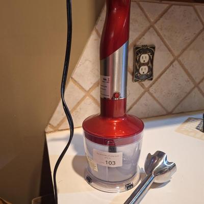 Red and silver immersion hand blender that also has a base- use it either way.