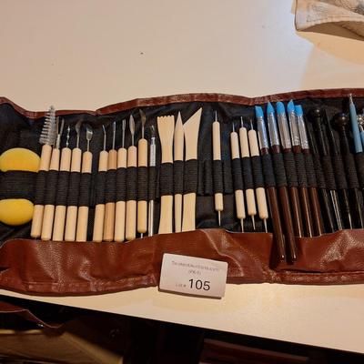 pottery and clay sculpting tool set in a brown roll-up carrying case. 