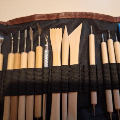 pottery and clay sculpting tool set in a brown roll-up carrying case. 