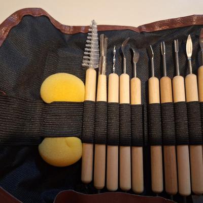 pottery and clay sculpting tool set in a brown roll-up carrying case. 