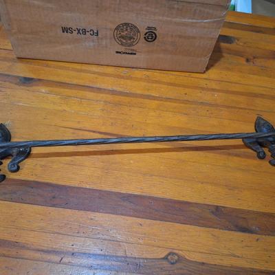 cast iron towl bar with twisted bar and Fleur de lis ends. Holes to screw them to the wall