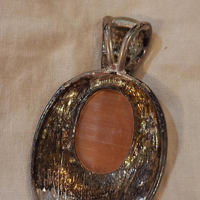 oval pendant silver town with orange stone
