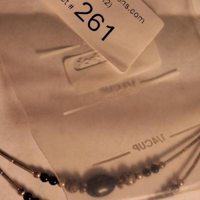 double strand necklace featuring black onyx and silver beads