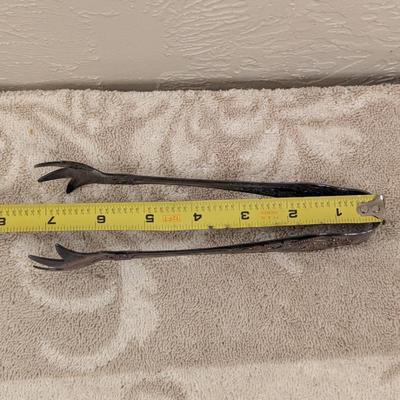 vintage silverplate sugar tongs with talon or claw style ends. By Wallace
