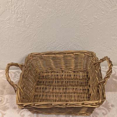 rectangular woven wicker storage basket with handles. 