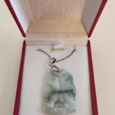 Sale Photo Thumbnail #381: This lot is for a Carved Jade Horse Pendant with Sterling Silver Chain.  This very handsome item comes in a new presentation box. The carving of the horse has been nicely accomplished.  The chain is marked Italy 925.