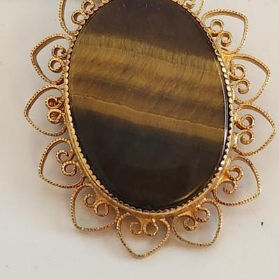 Sale Photo Thumbnail #388: This lot is for a Monet Onyx Pendant in 12KGF Mounting.  This handsome necklace sports a nice sliced onyx stone.  The chain is marked Monet but appears to be a gold-toned metal.