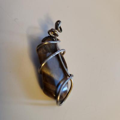 Sale Photo Thumbnail #408: This lot is for a Handmade Rock Pendant.  Nicely fashioned and ready to hang on your favorite chain or whatever.  Interesting for so many uses.