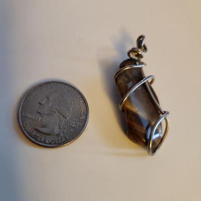 Sale Photo Thumbnail #409: This lot is for a Handmade Rock Pendant.  Nicely fashioned and ready to hang on your favorite chain or whatever.  Interesting for so many uses.