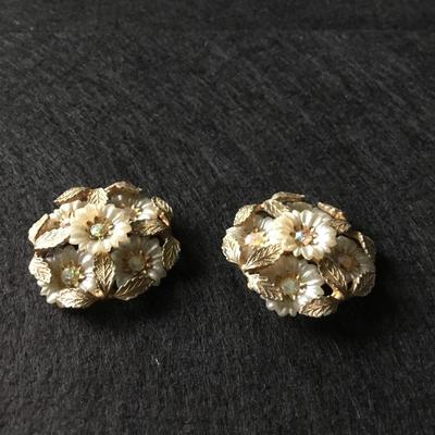 Vintage gold tone Coro flower cluster clip on earrings with white petals and rhinestone centers