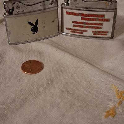 Sale Photo Thumbnail #130: Playboy lighter has some paint loss. 
Balboa lighter advertised for "Rocky" (lol) Mountain Tools
I believe both with work with new flints & a good cleaning & filling.
