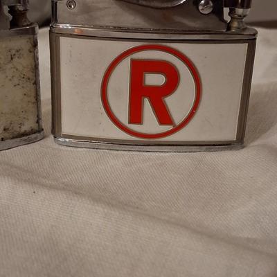 Sale Photo Thumbnail #137: Playboy lighter has some paint loss. 
Balboa lighter advertised for "Rocky" (lol) Mountain Tools
I believe both with work with new flints & a good cleaning & filling.