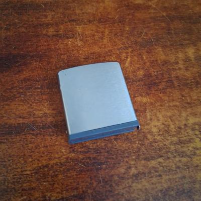 Sale Photo Thumbnail #141: 1960s Zippo Tape measurer. Excellent condition. Tape itself is in excellent condition with the early script Zippo name on the tape. Only slight wear on the case. This item is no longer made. Production stopped in 2007.