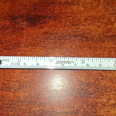 Sale Photo Thumbnail #144: 1960s Zippo Tape measurer. Excellent condition. Tape itself is in excellent condition with the early script Zippo name on the tape. Only slight wear on the case. This item is no longer made. Production stopped in 2007.