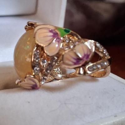 Sale Photo Thumbnail #174: Crystal accents. This ring is statement upon statement.  The Flowers wrap around the ring, flow down the shoulders & are pepper with Crystal accents. Size 7 1/2