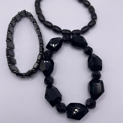 Green and black stretch bracelets