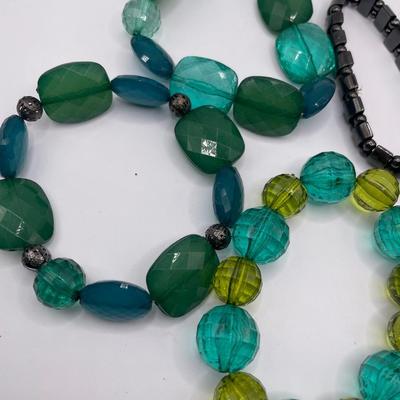 Green and black stretch bracelets