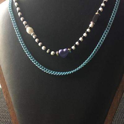 Layered, beaded, and chain necklace featuring a Purple Heart charm