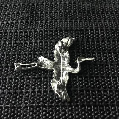 Silver tone bird brooch with green and blue rhinestones