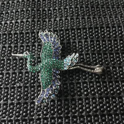Silver tone bird brooch with green and blue rhinestones