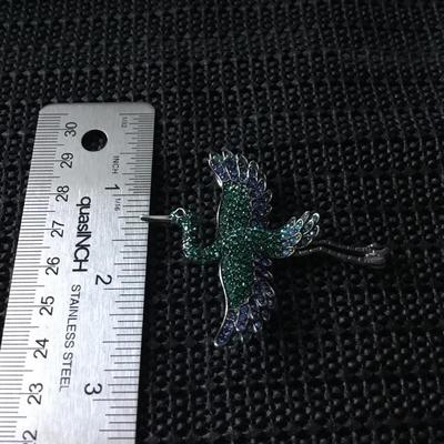 Silver tone bird brooch with green and blue rhinestones