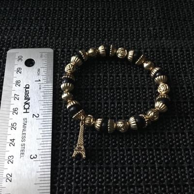 Gold tone and black beaded Eiffel Tower charm bracelet