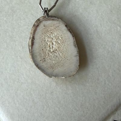 Sale Photo Thumbnail #388: Liquid Silver with turquoise nuggets on the 18" chain.  The turquoise stone is encased in silver and inlaid into the antler.  
What a conversation piece!