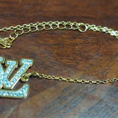 Louis Vuitton rhinestone initial bracelet 18 karat gold overlays stainless steel