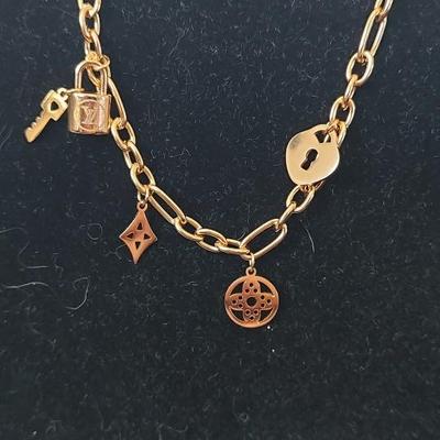 Louis Vuitton Lock and key bracelet 18 karat gold over stainless steel