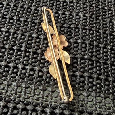 vintage Krementz gold-tone bar brooch featuring a rose and leaf motif.