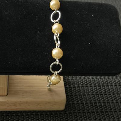 silver-tone bracelet with faux ivory-color pearls and open silver-tone circles. SHB