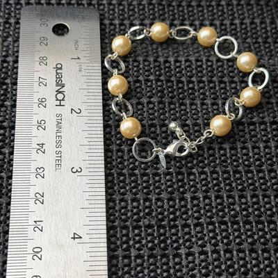 silver-tone bracelet with faux ivory-color pearls and open silver-tone circles. SHB