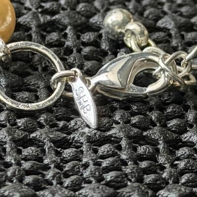 silver-tone bracelet with faux ivory-color pearls and open silver-tone circles. SHB