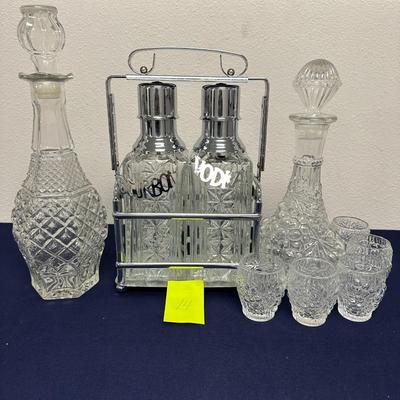 Sale Photo Thumbnail #30: Lot of
Labeled Bourbon & Vodka decanters in holder.
2 wine or liquor decanters, one has matching glasses