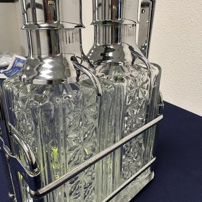 Sale Photo Thumbnail #32: Lot of
Labeled Bourbon & Vodka decanters in holder.
2 wine or liquor decanters, one has matching glasses